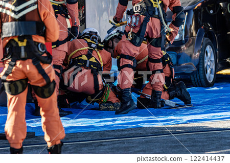 Rescue team members perform rescue training using a hydraulic cutter to cut off the roof of a car that has overturned in an accident during a fire drill at the New Year's ceremony. Rescue team members perform rescue training using a hydraulic cutter to cut off the roof of a car that has overturned in an accident during a fire drill at the New Year's ceremony. 122414437