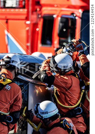 Rescue team members perform rescue training using a hydraulic cutter to cut off the roof of a car that has overturned in an accident during a fire drill at the New Year's ceremony. Rescue team members perform rescue training using a hydraulic cutter to cut off the roof of a car that has overturned in an accident during a fire drill at the New Year's ceremony. 122414454