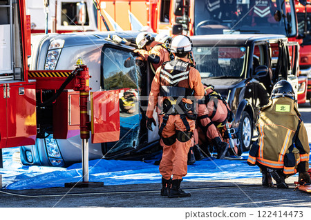 Rescue team members perform rescue training using a hydraulic cutter to cut off the roof of a car that has overturned in an accident during a fire drill at the New Year's ceremony. Rescue team members perform rescue training using a hydraulic cutter to cut off the roof of a car that has overturned in an accident during a fire drill at the New Year's ceremony. 122414473