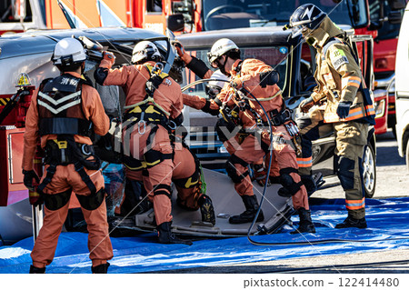 Rescue team members perform rescue training using a hydraulic cutter to cut off the roof of a car that has overturned in an accident during a fire drill at the New Year's ceremony. Rescue team members perform rescue training using a hydraulic cutter to cut off the roof of a car that has overturned in an accident during a fire drill at the New Year's ceremony. 122414480