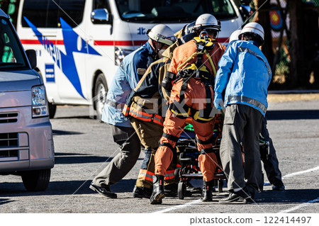A rescue team member transports an injured person on a stretcher after being rescued by firefighters during a New Year's fire drill. A rescue team member transports an injured person on a stretcher after being rescued by firefighters during a New Year's fire drill. 122414497