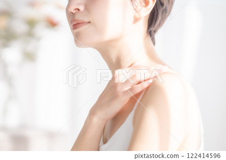 A middle-aged woman bathed in the refreshing morning sun 122414596