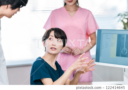 A doctor checking the medical records on the monitor A doctor checking the medical records on the monitor 122414645
