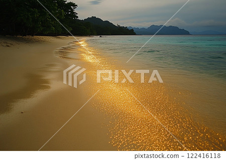 Golden sunlight reflects on gentle waves at a tropical beach during sunset in a serene coastal area 122416118