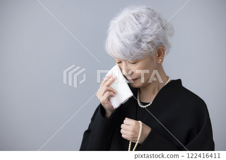 Funeral: Senior woman wiping tears with a handkerchief Funeral: Senior woman wiping tears with a handkerchief 122416411