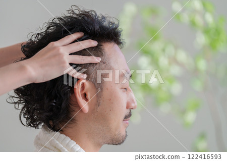 Man receiving a head massage Man receiving a head massage 122416593