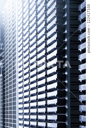 cluster of hard drives stacked inside data storage cabinet 122417108