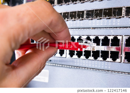 hand with red ethernet cable 122417146