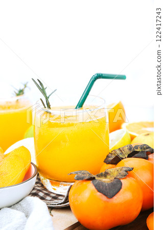 persimmon juice in a glass And there are orange slices. Isolated white background, healthy drink concept persimmon juice in a glass And there are orange slices. Isolated white background, healthy drink concept 122417243