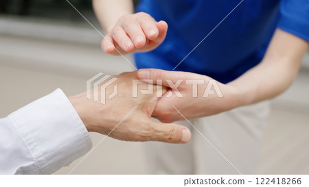 Caregiver's hands reaching out to the elderly Caregiver's hands reaching out to the elderly 122418266