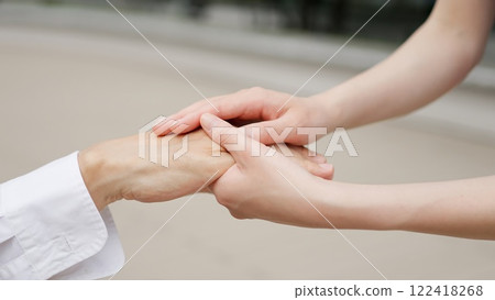 Caregiver's hands reaching out to the elderly Caregiver's hands reaching out to the elderly 122418268