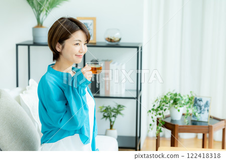 Woman relaxing in the living room Woman relaxing in the living room 122418318
