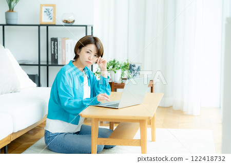 Young woman working on a laptop at home Young woman working on a laptop at home 122418732