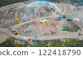 aerial view shot mining, dumpers, quarrying extractive industry stripping work. Big Mining Trucks. View from drone at opencast mining with lots of machinery trucks. High quality photo 122418790