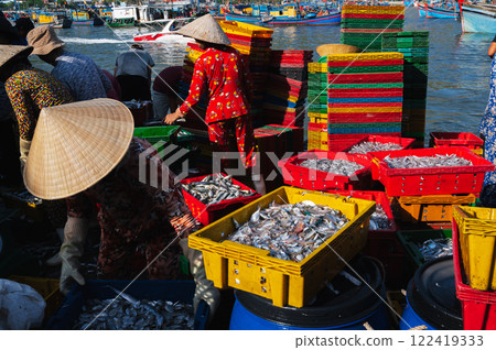 Vietnamese people in a fishing village collect fresh fish from a boat and open the market in the early morning. Vietnam, Nha Trang Vietnamese people in a fishing village collect fresh fish from a boat and open the market in the early morning. Vietnam, Nha Trang 122419333