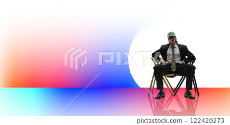 Stylish young man in suit and green cap confidently sitting on chair, white background with colorful gradient elements. Stylish young man in suit and green cap confidently sitting on chair, white background with colorful gradient elements. 122420273
