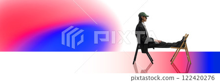 Side view of young man in suit and cap sitting on chair in relaxed pose against white background with colorful gradient elements. Side view of young man in suit and cap sitting on chair in relaxed pose against white background with colorful gradient elements. 122420276