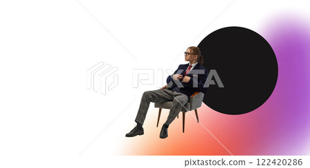 Young stylish man in navy suit sitting on chair against white background with circular shape and colorful gradient. Young stylish man in navy suit sitting on chair against white background with circular shape and colorful gradient. 122420286