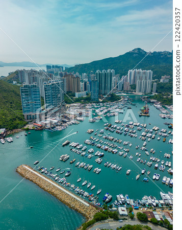 Vertical aerial view of apartment buildings and marina in Hong Kong 122420357