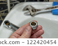 Dirt on the filter mesh of a disassembled mixer. Unclogging a bathroom faucet. Water quality 122420454