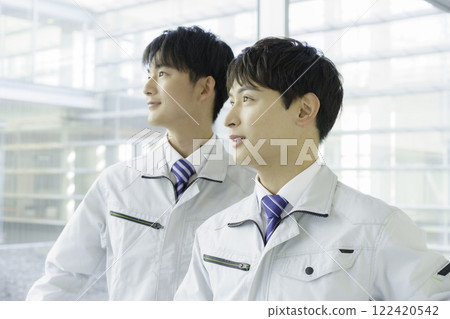 Portrait of two young men standing in work clothes 122420542