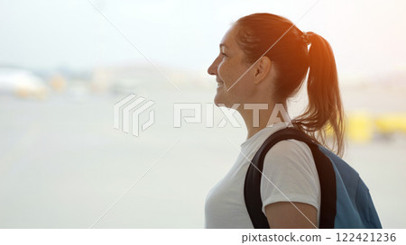 Young tourist woman looking at airplanes taking off at airport 122421236