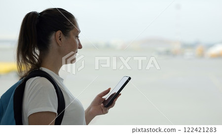 Tourist using smartphone at airport 122421283