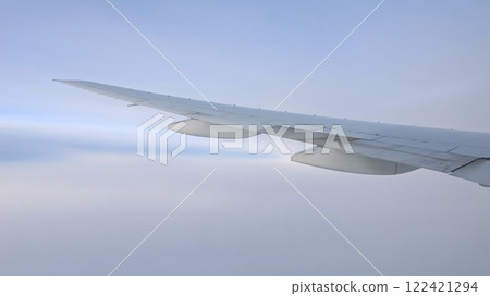 Airplane wing soaring through the sky 122421294