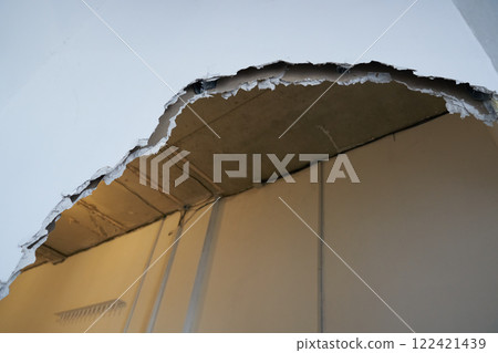 Broken drywall, a background crack with a white wall texture. With space to copy. High quality photo Broken drywall, a background crack with a white wall texture. With space to copy. High quality photo 122421439