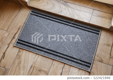 Door Mat Entryway Outdoor Mat Welcome Mats Entry Grey Mat. Wooden Brown floor. Top View 122421940