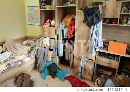 Scattered Things in Wardrobe, Disorder in Clothes. Childrens room is littered with clutter Scattered Things in Wardrobe, Disorder in Clothes. Childrens room is littered with clutter 122421944