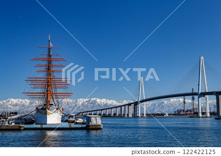 Kaiwomaru and Shinminato Bridge with snow-capped mountains in the background Kaiwomaru and Shinminato Bridge with snow-capped mountains in the background 122422125