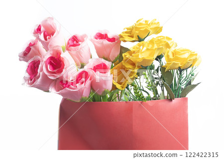 Vibrant bouquet of pink and yellow roses in a stylish red gift bag Vibrant bouquet of pink and yellow roses in a stylish red gift bag 122422315
