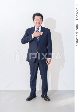 Full body of a businessman holding his hand on his chest 122422402