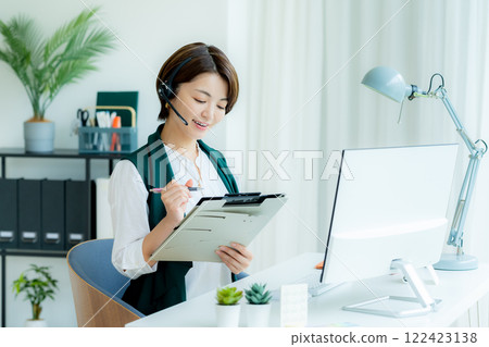 Female operator working in the office Female operator working in the office 122423138