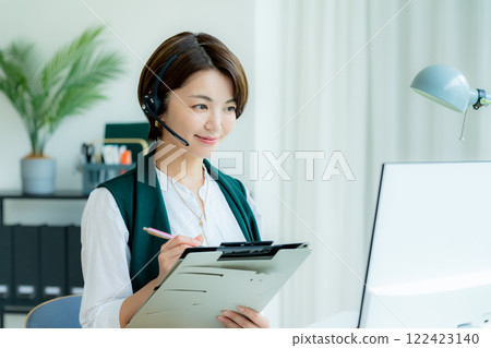 Female operator working in the office Female operator working in the office 122423140