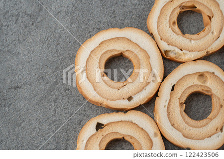 Wheel-shaped wheat gluten on a gray background Wheel-shaped wheat gluten on a gray background 122423506