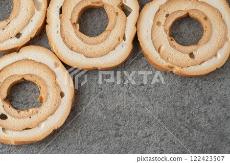Wheel-shaped wheat gluten on a gray background Wheel-shaped wheat gluten on a gray background 122423507