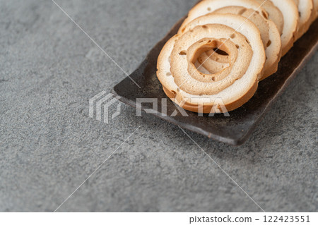 Wheel-shaped wheat gluten on a gray background Wheel-shaped wheat gluten on a gray background 122423551