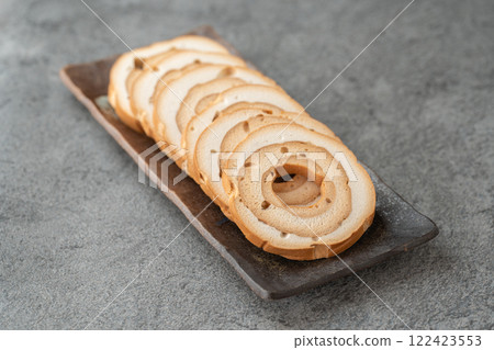Wheel-shaped wheat gluten on a gray background Wheel-shaped wheat gluten on a gray background 122423553