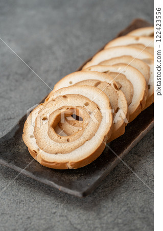 Wheel-shaped wheat gluten on a gray background Wheel-shaped wheat gluten on a gray background 122423556
