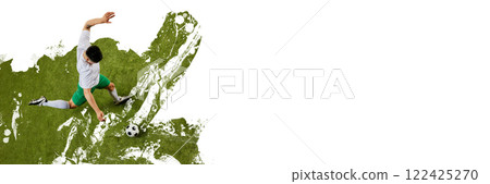 Banner. Creative art design. Top view of male soccer player in uniform performs precise kick, focused on ball against textured green paint splash background. 122425270