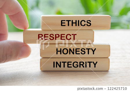 Ethics, respect, honesty and integrity text on wooden blocks with blurred nature background Ethics, respect, honesty and integrity text on wooden blocks with blurred nature background 122425710