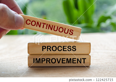 Continuous process improvement text on wooden blocks. Business strategy and improvement concept 122425715