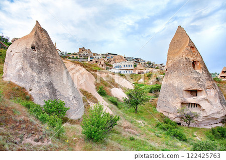 Unique fairy chimneys and charming homes in Cappadocia's enchanting landscape at sunset Unique fairy chimneys and charming homes in Cappadocia's enchanting landscape at sunset 122425763