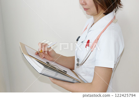 Image of a nurse taking notes Image of a nurse taking notes 122425794