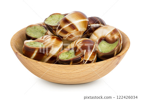 escargot snail filled with garlic and parsley butter in wooden bowl isolated on white background escargot snail filled with garlic and parsley butter in wooden bowl isolated on white background 122426034