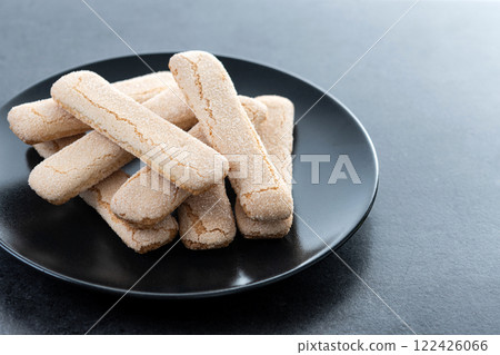 Italian biscuits ladyfingers savoiardi on black slate background 122426066