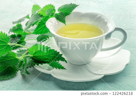 Nettle tea. Medicinal herbal tea with Urtica leaves. Fresh wild herb 122426218
