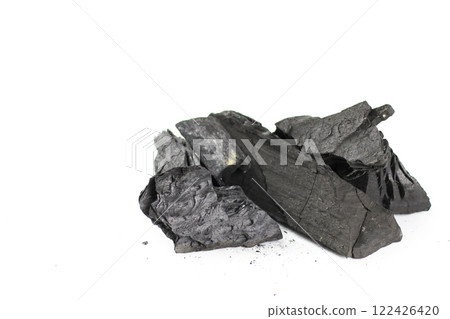 Isolated pieces of black charcoal resting on a clean white background, showcasing its rough texture and deep, rich color. Often used for grilling, art, and filtration, charcoal symbolizes both energy Isolated pieces of black charcoal resting on a clean white background, showcasing its rough texture and deep, rich color. Often used for grilling, art, and filtration, charcoal symbolizes both energy 122426420